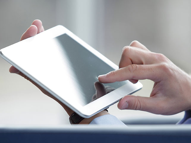 closeup of a tablet with a finger using the touchscreen